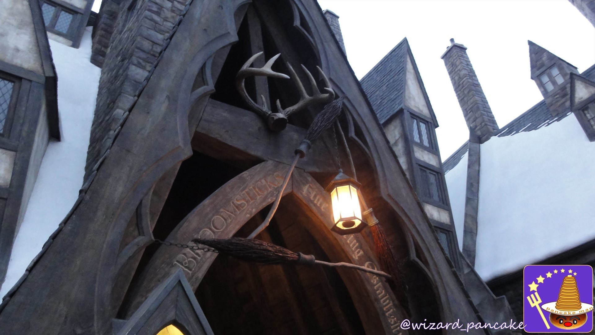 THREE BOOM STICKS Three Broomsticks 'Three magic brooms' above the entrance Â USJ Harry Potter area.