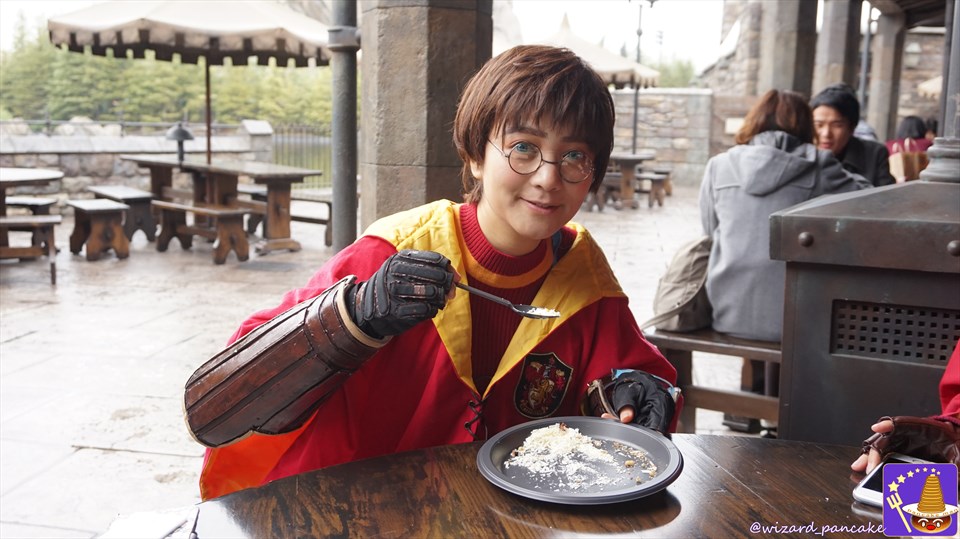 Nah dressed as a Harry Potter lookalike eating Three Broomsticks' winter-only Christmas dessert feast.