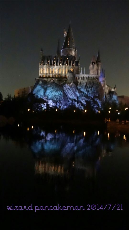 Hogwarts Castle and upside down Hogwarts at night across the lake USJ Harry Potter area